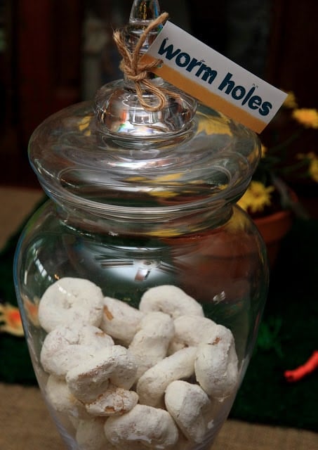 Glass jar with treats and label that says \"worm holes\"