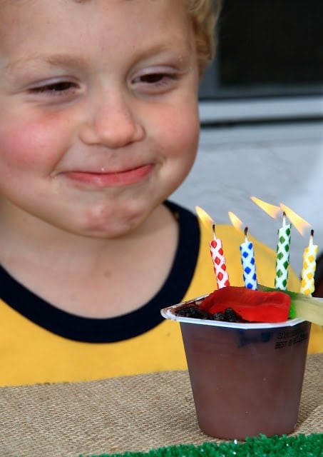 A little boy blowing out birthday candles