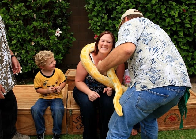 A woman holding an albino boa