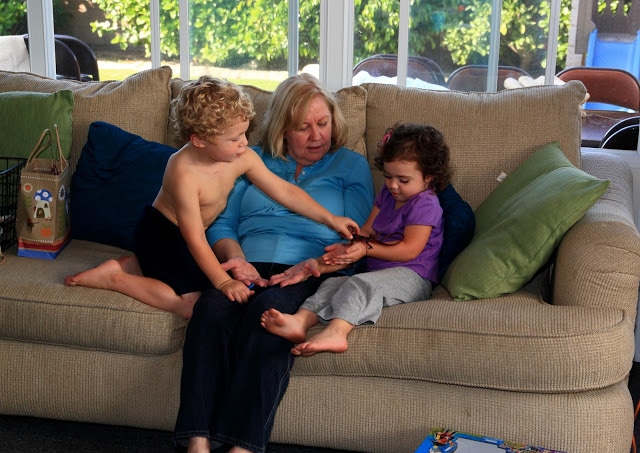 A woman and children sitting on a couch