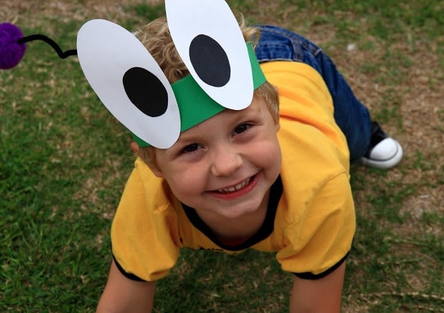 A little boy wearing a bug hat