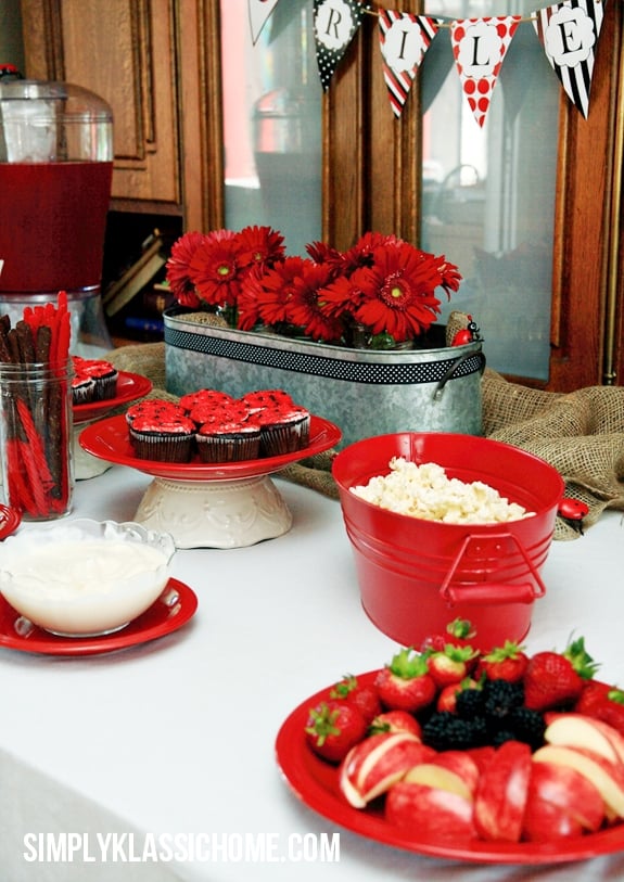 A table topped with plates of food and flowers