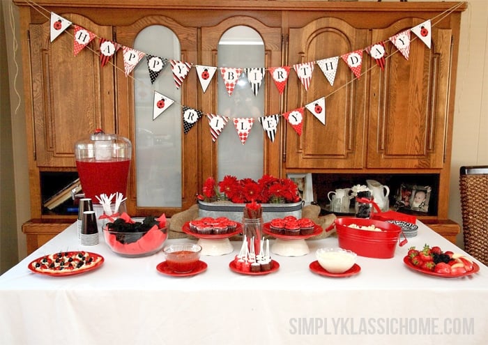 A kitchen with food, punch, and a Happy Birthday sign