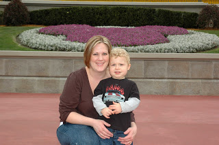 A young boy sitting with his mom