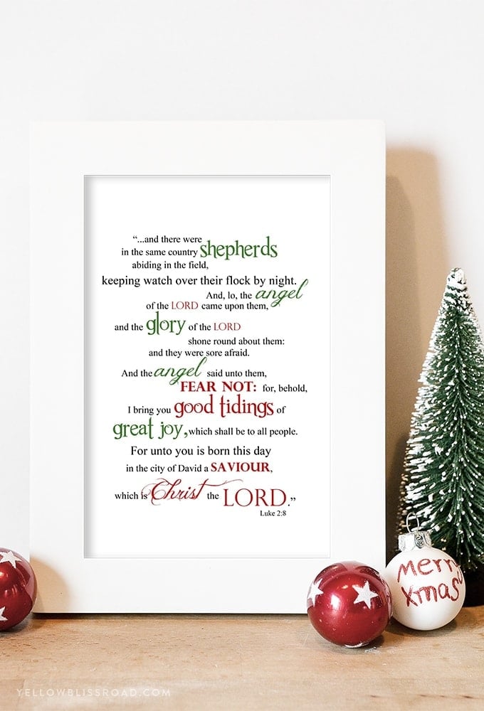 A free Christmas printable with scripture from Luke 2:8 in a white frame surrounded by Christmas decor.