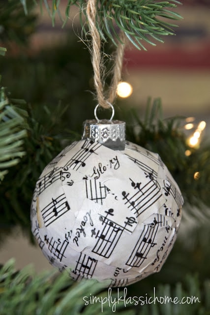 A close up of a glass ornament covered in sheet music