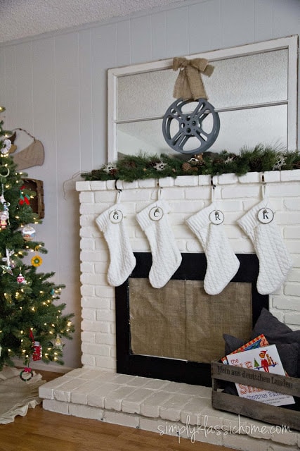 Christmas tree next to fireplace with stockings