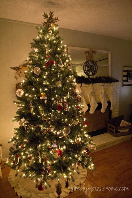 Christmas tree next to fireplace with stockings