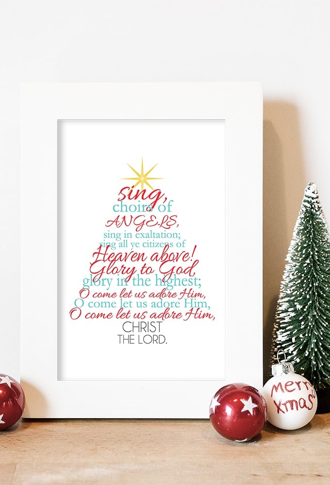 Free Christmas printable with the Christmas carol "O Come All Ye Faithful" lyrics displayed in aqua and red.