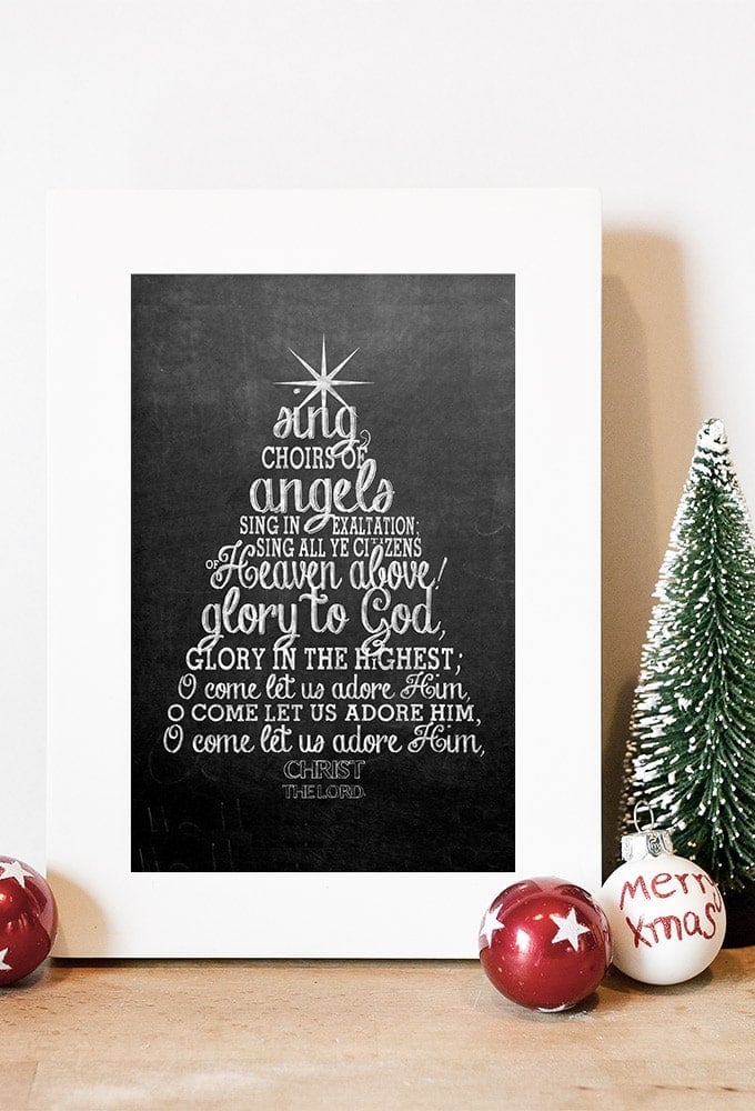 Free Christmas printable with the Christmas carol "O Come All Ye Faithful" lyrics displayed on a chalkboard baground.