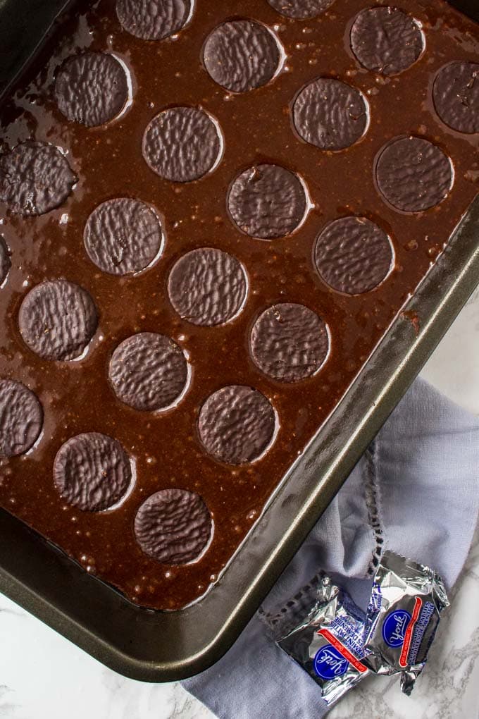 A pan of brownie batter with York Peppermint Patties.