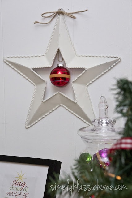 White barn star with a red ornament
