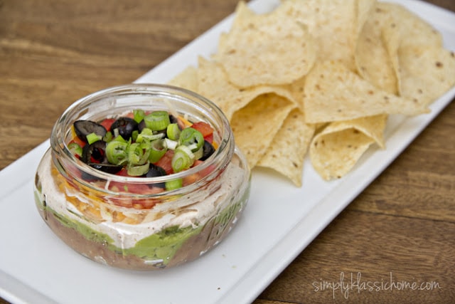 A bowl of Mexican dip with chips