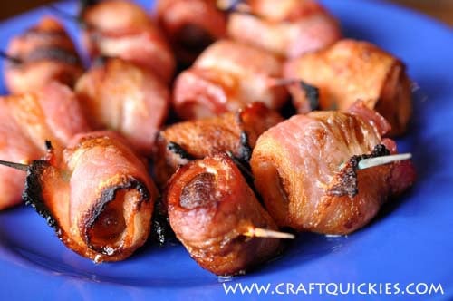 Bacon wrapped water chestnuts on a blue plate
