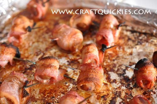 Cooked bacon wrapped water chestnuts on a sheet pan