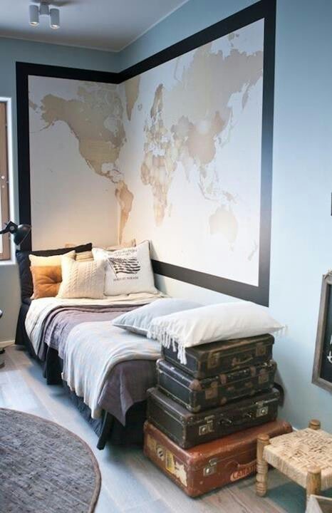 A bedroom with a bed and map on the wall