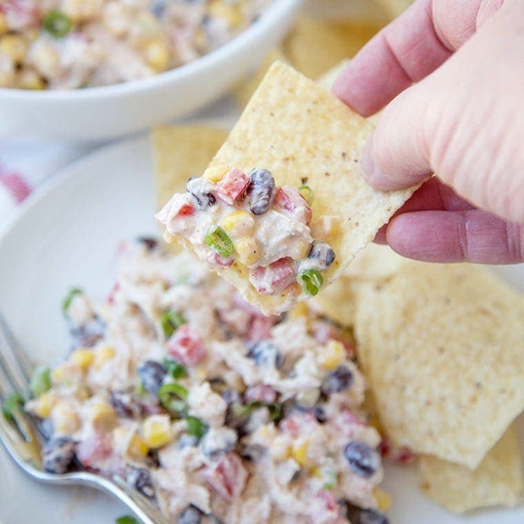 Skinny Southwest Chicken Salad scooped onto a tortilla chip