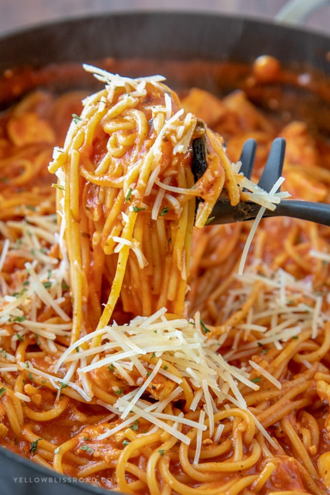 A pan of One Pot Chicken Spaghetti, with a portion lifted to be served.