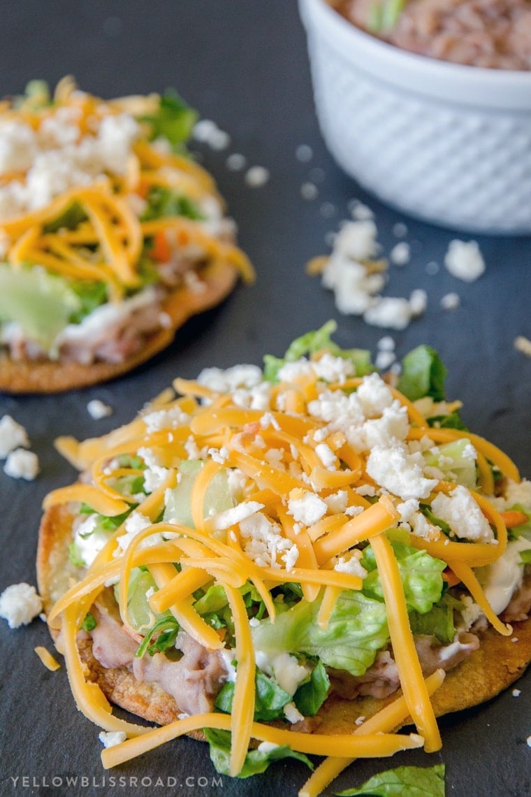 baked tostada shells with beans, lettuce and cheese