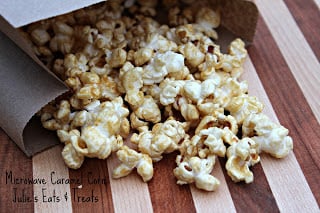A wooden cutting board with Caramel Popcorn on top