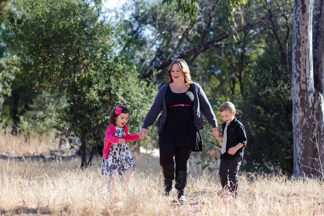 A mom and two children standing outside