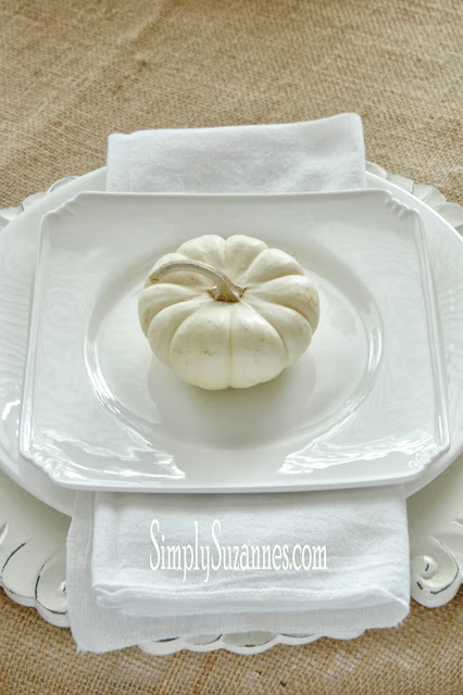 A white pumpkin sitting on a plate