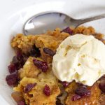 A plate of cobbler with ice cream on top