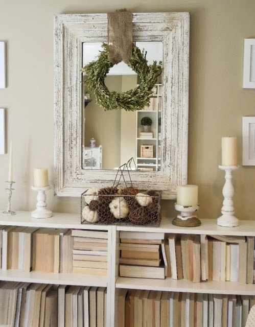 Decorated room with white bookshelf and mirror