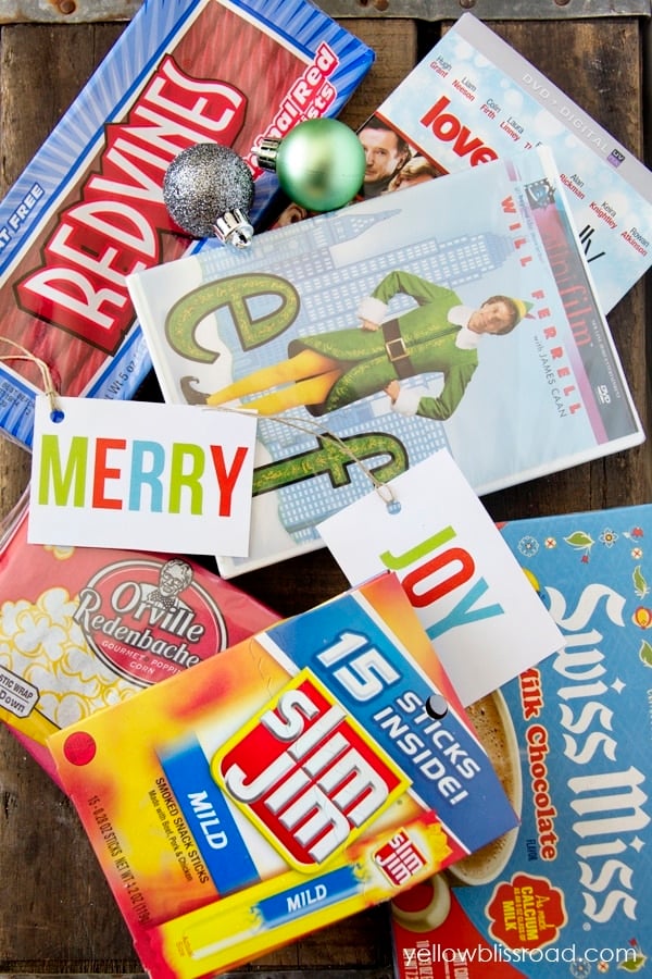 A group of Christmas movies, popcorn, and candy on a tabletop