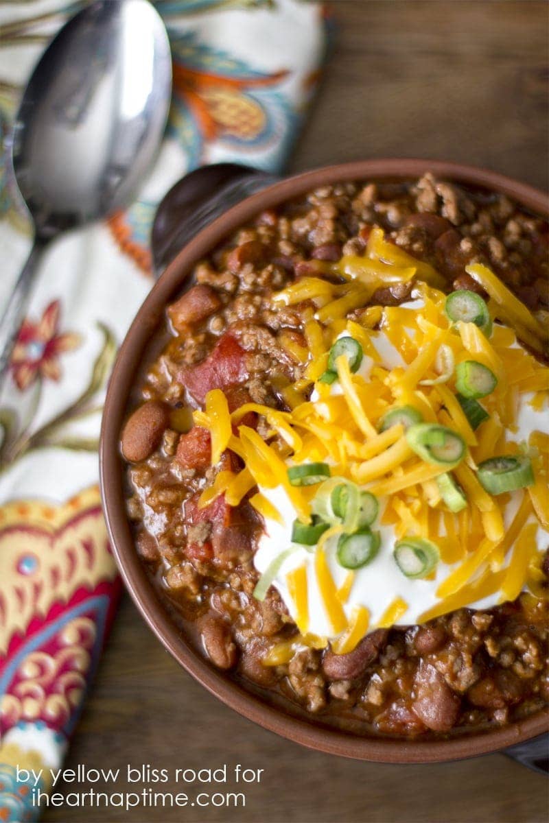 chili in a bowl with sour cream and cheese