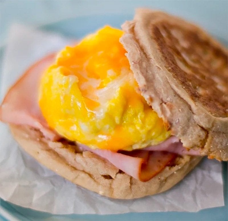 homemade egg mcmuffin sandwich on a blue plate