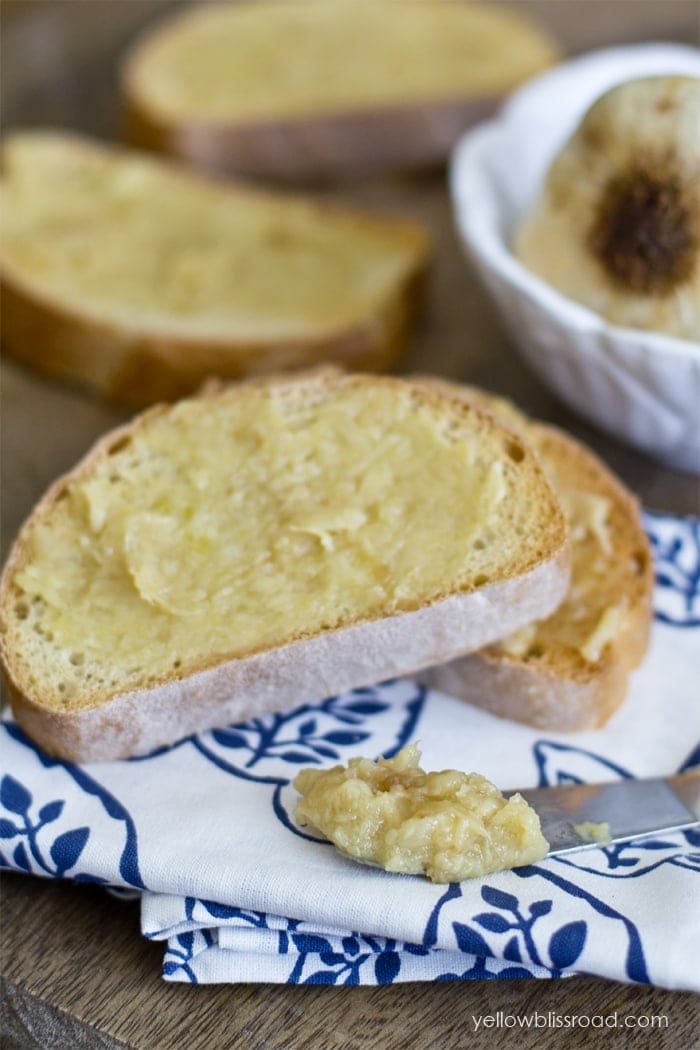Slices of french bread with roasted garlic spread on top. 
