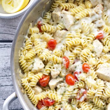A pan of chicken, tomatoes, and pasta