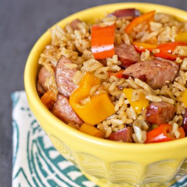 A bowl of sausage, rice, and peppers