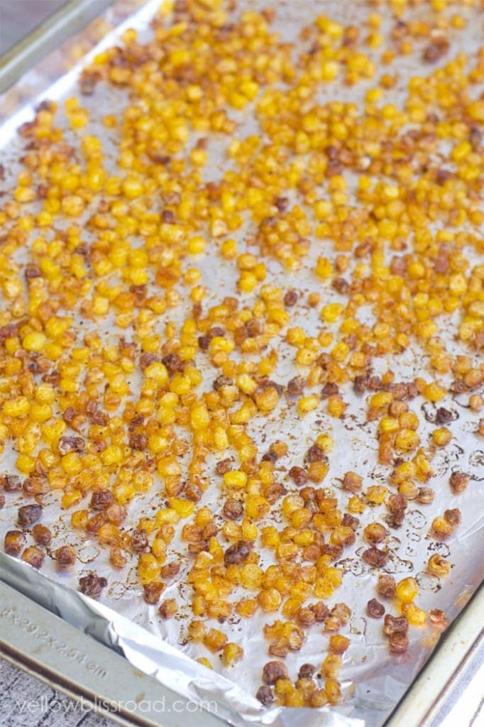 roasted corn kernels on a foil lined baking sheet