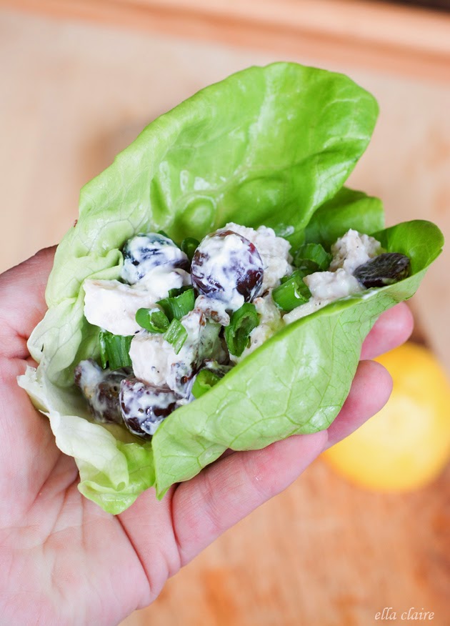 A close up of a hand holding a lettuce wrap