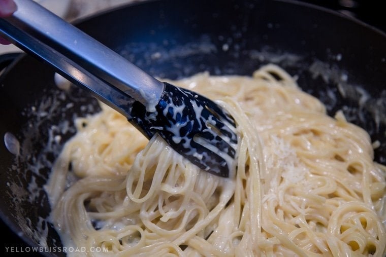 One Pan Garlic Parmesan pasta is light enough to serve as a main dish, or as a side dish. It's a simple one pot pasta that's ready in 20 minutes! One Pan Garlic Parmesan Pasta being stirred together with tongs