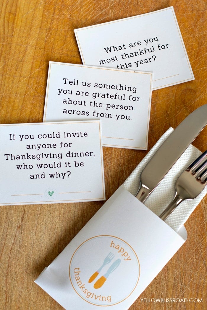 Silverware and napkin in a packet, wood background, Free Printable Conversation Starters for Thanksgiving