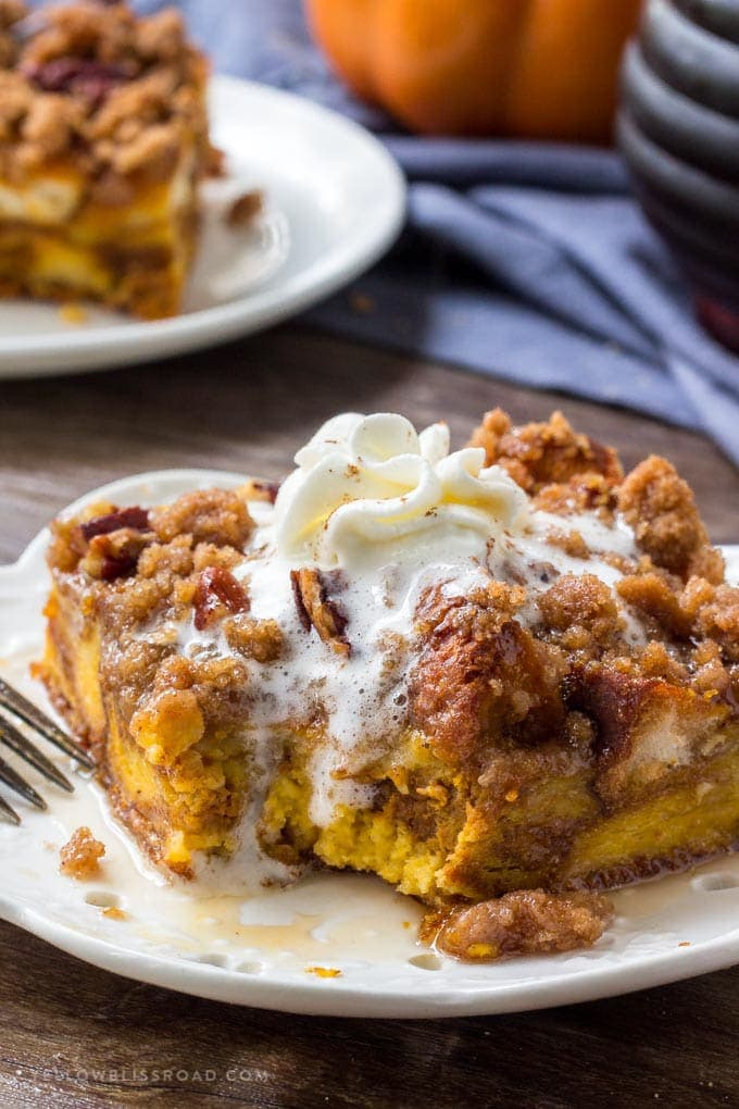 A delicious slice of Pumpkin Pie French Toast Bake recipe with whipped cream and maple syrup.