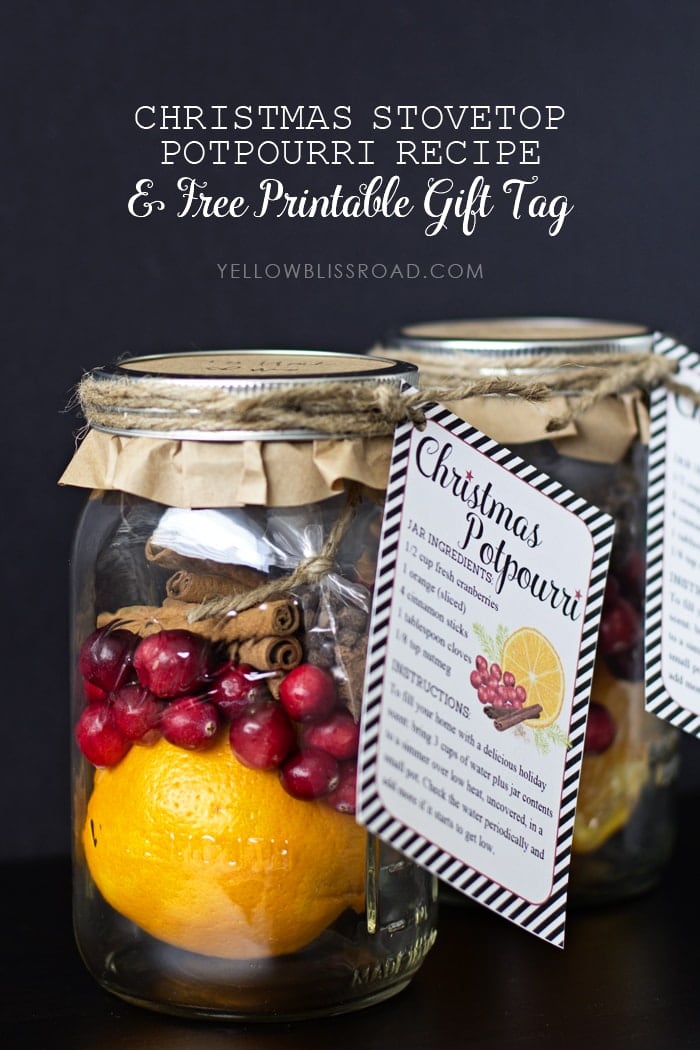 Orange, Cranberries and cinnamon sticks in a glass jar with a recipe tag attached for Christmas Stovetop Potpourri gift idea.