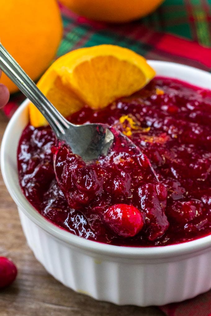 Homemade Cranberry Sauce will be the perfect compliment to your turkey, and cranberry orange sauce makes a fantastic relish for your turkey sandwiches, too! A spoonful of homemade cranberry orange sauce.
