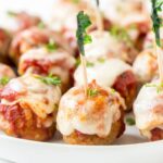 A close up of meatballs with cheese