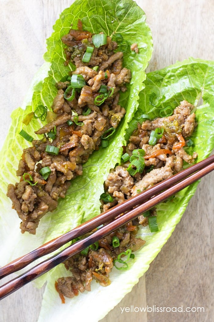 Teriyaki Turkey Lettuce Wraps with chopsticks on a wood background