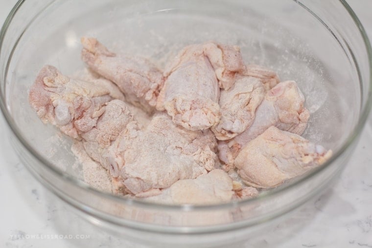 chicken wings with flour in a bowl