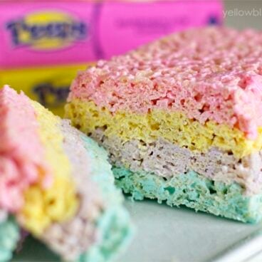 Rice krispie treats with layered colors of pink, yellow, purple, and blue.