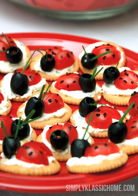 Edible ladybugs made out of tomatoes, olives, and crackers