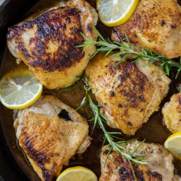 A close up of pan fried chicken thighs