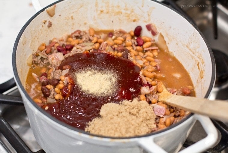 Baked Beans Mixed with brown sugar and barbecue sauce in a pot on the stove.