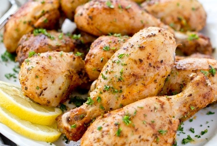 close up of chicken legs with lemon slices