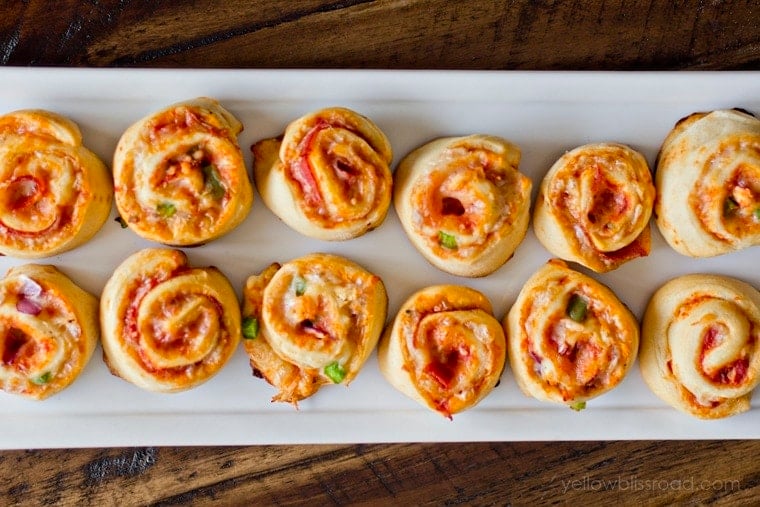 Pizza Pinwheels arrange on a white platter